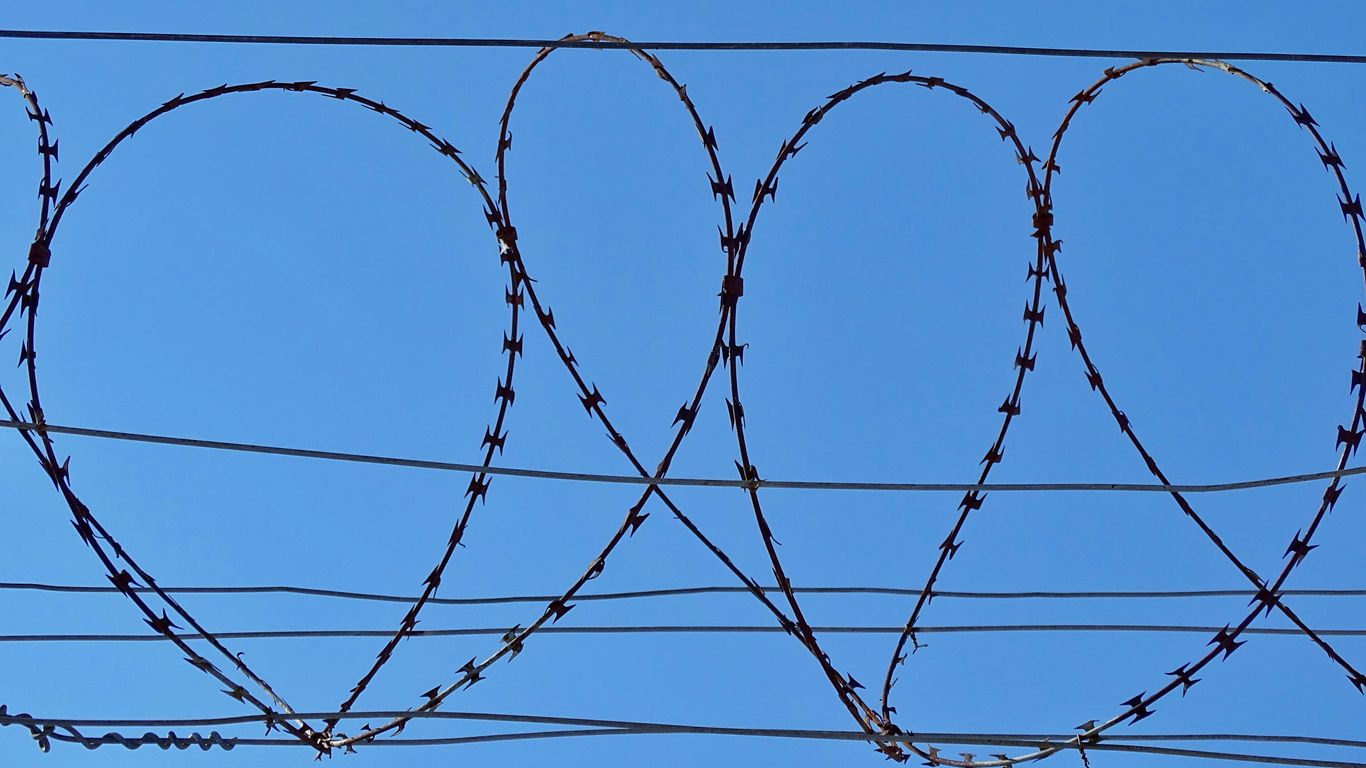 black wire fence under blue sky during daytime