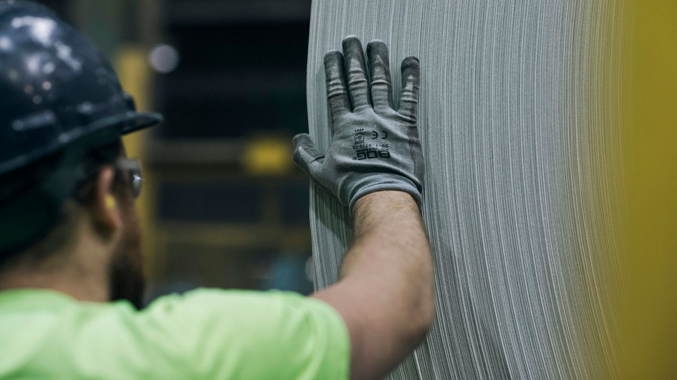 Factory worker inspecting finished ties