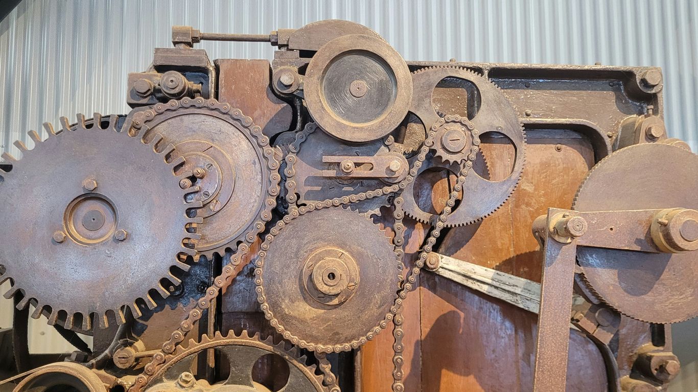 An old machine is sitting in a warehouse