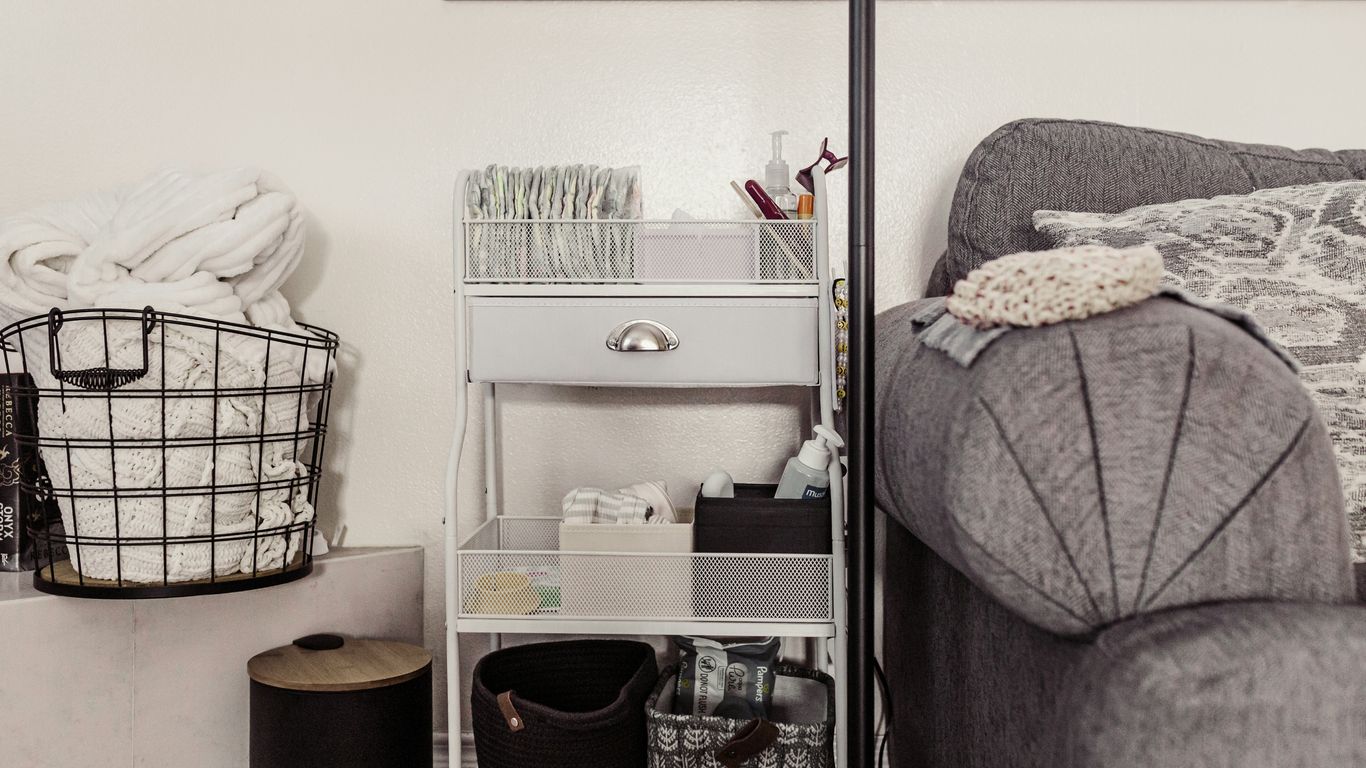 Storage cart with baskets next to sofa