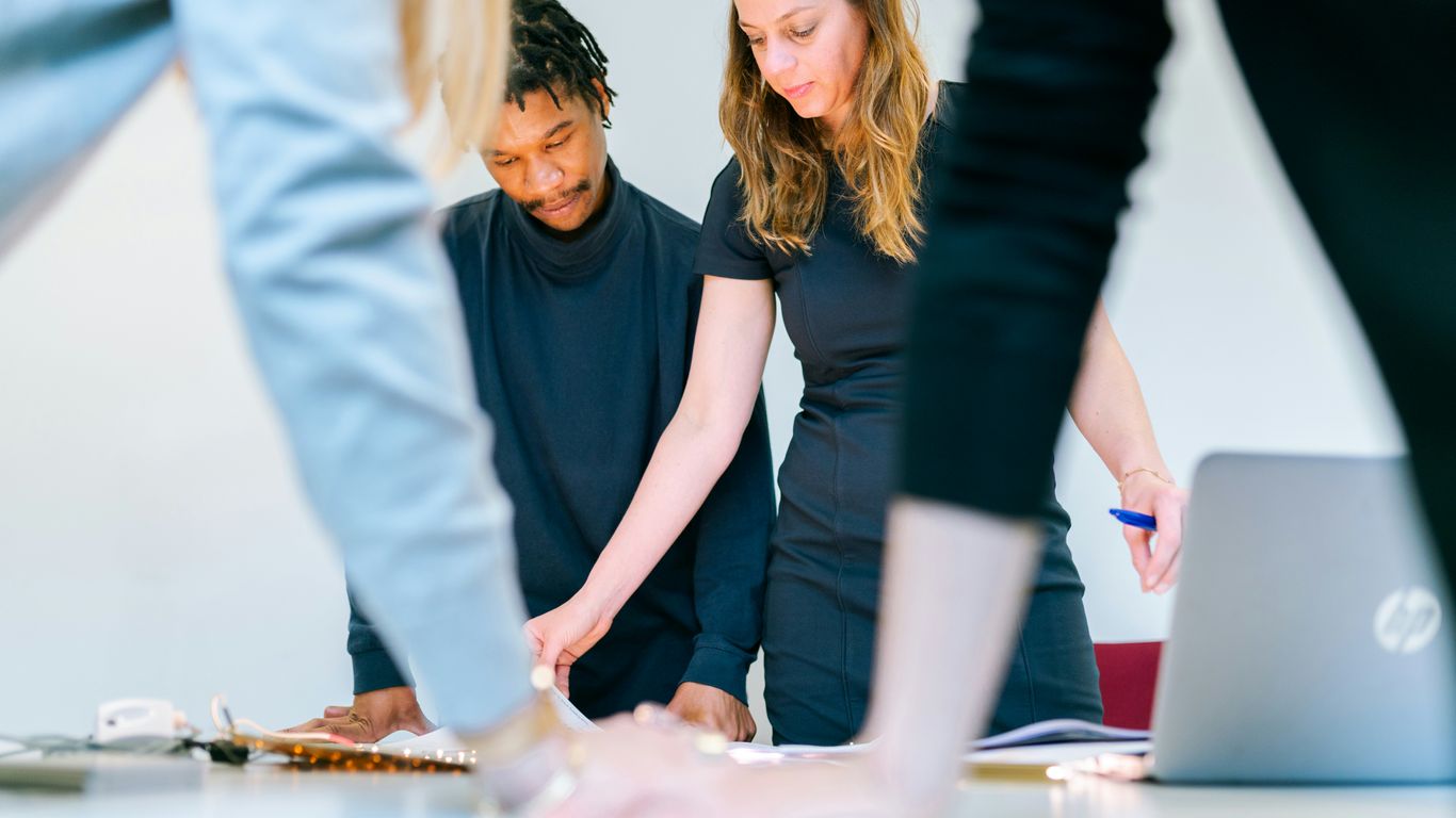 woman in black shirt holding woman in white pants