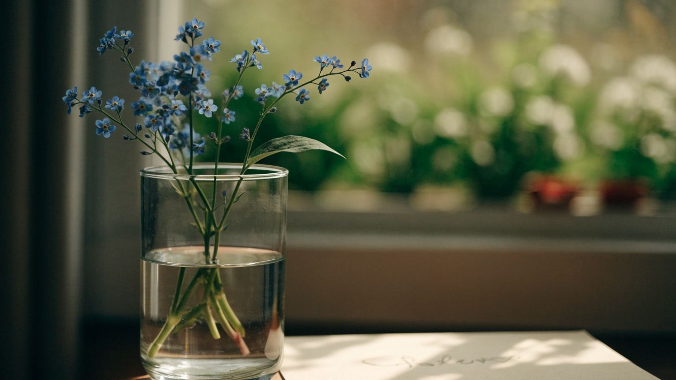 Small blue forget-me-nots beside a handwritten card