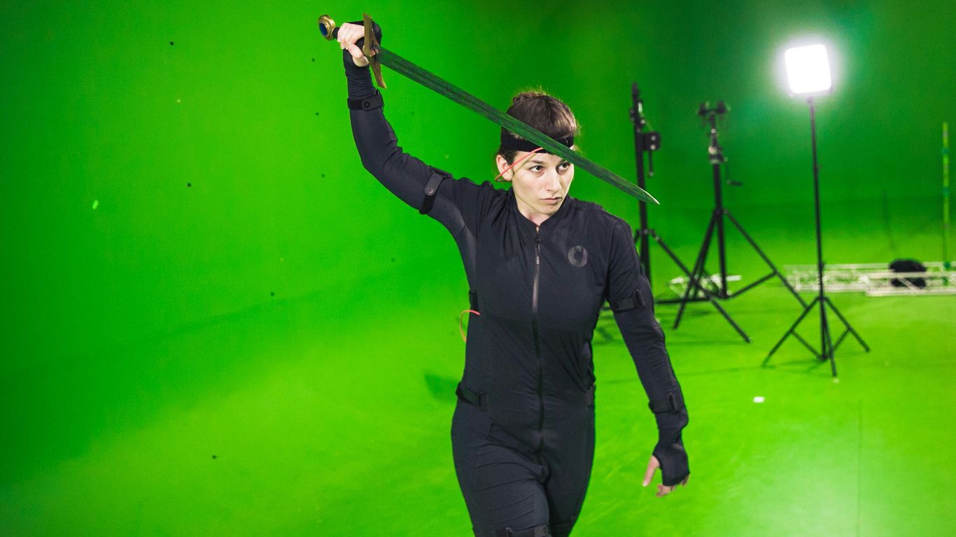 man in black long sleeve shirt and black pants holding microphone