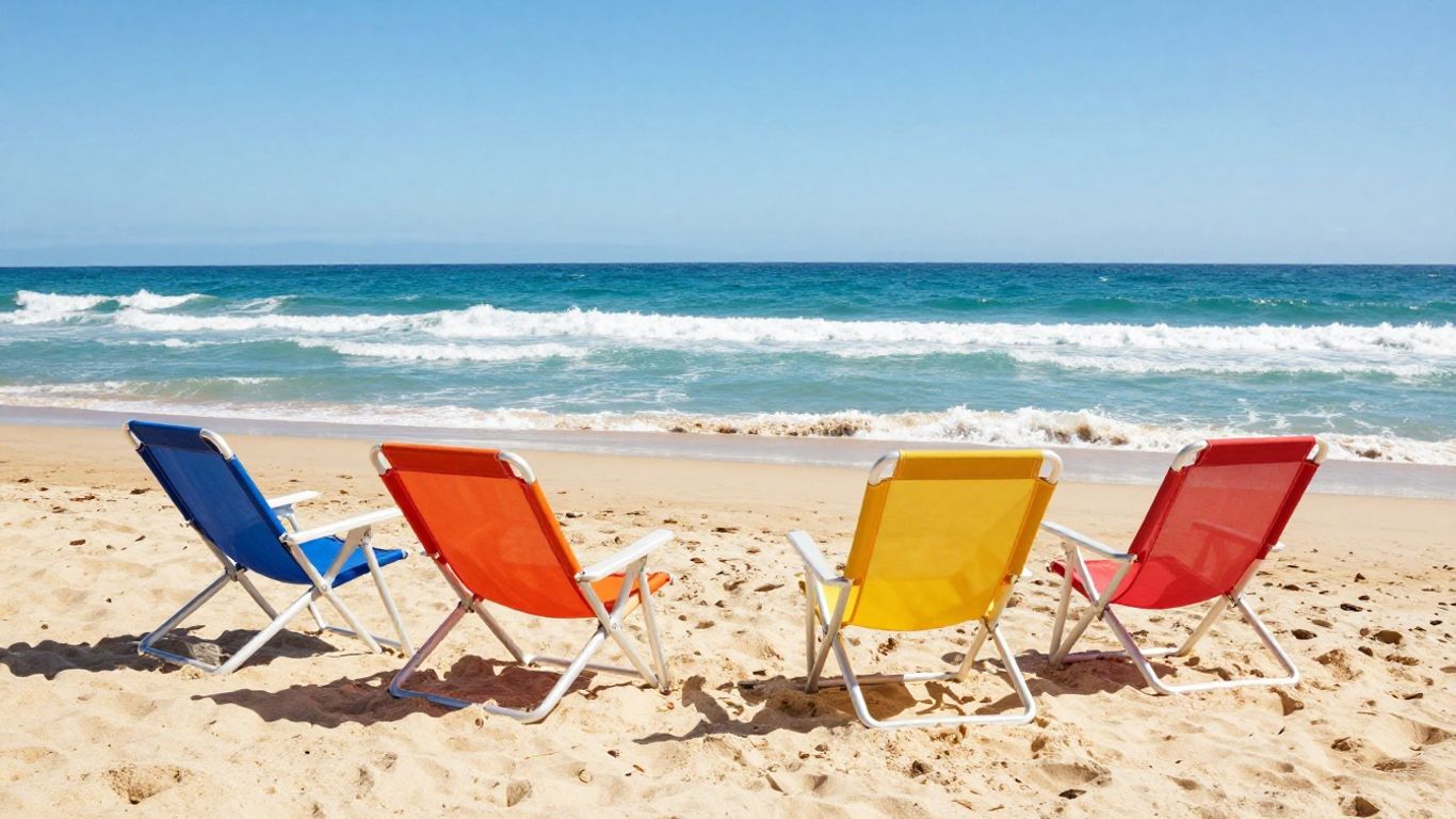 Foldable beach chairs on a sunny sandy shore.
