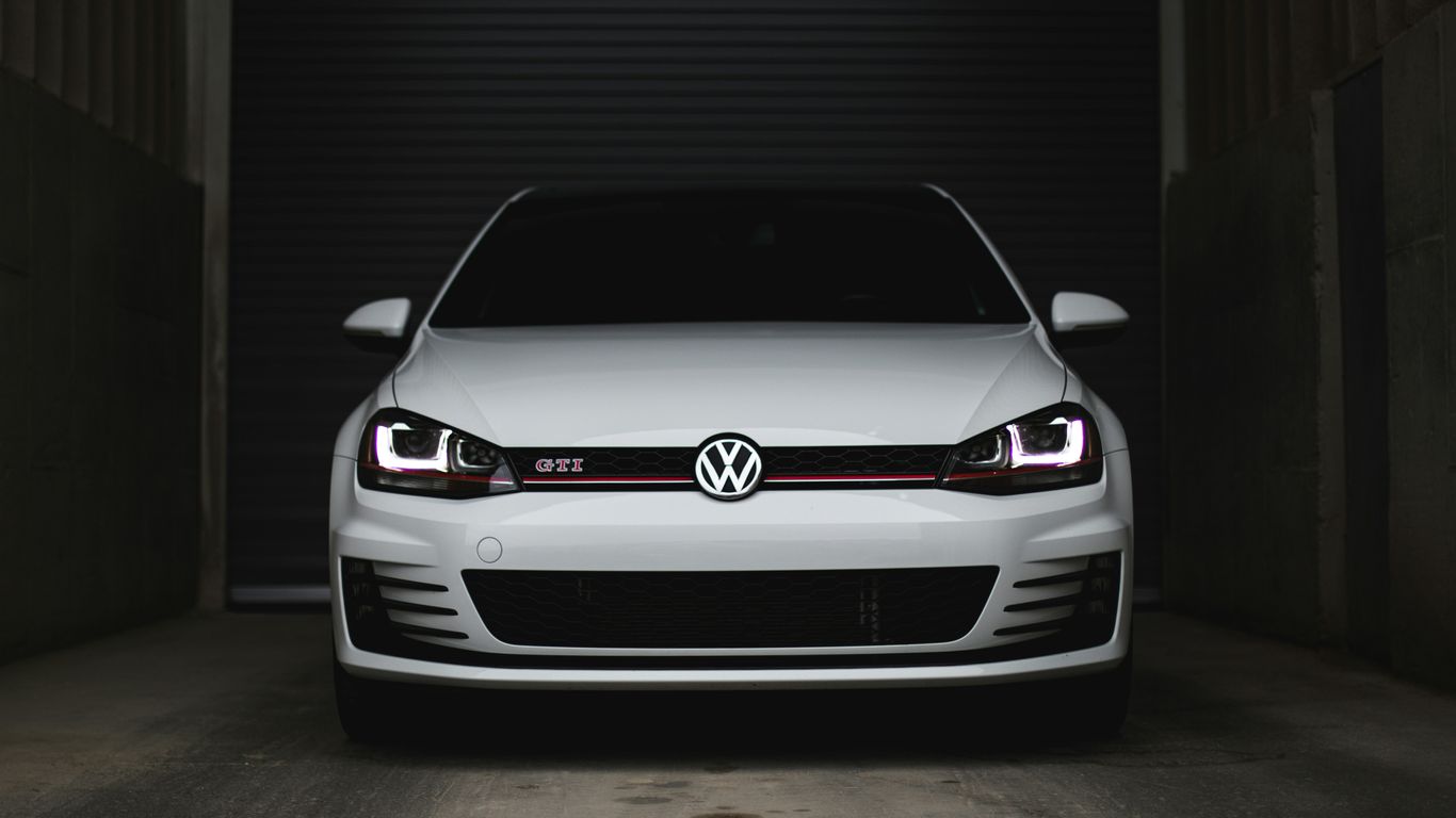 Mobile locksmith working beside Volkswagen vehicle
