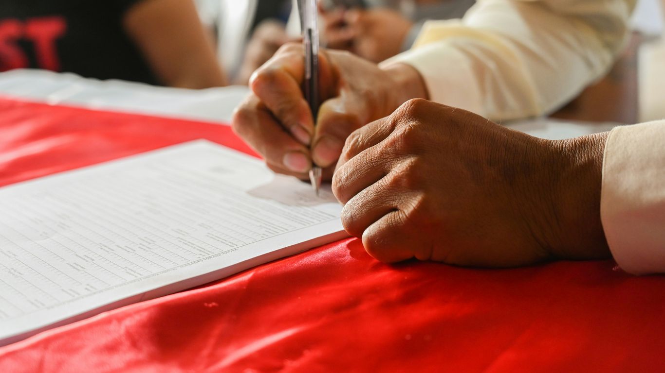 a person writing on a piece of paper