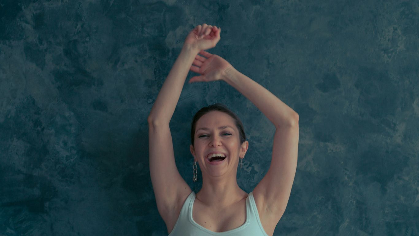 a woman with her arms up in the air