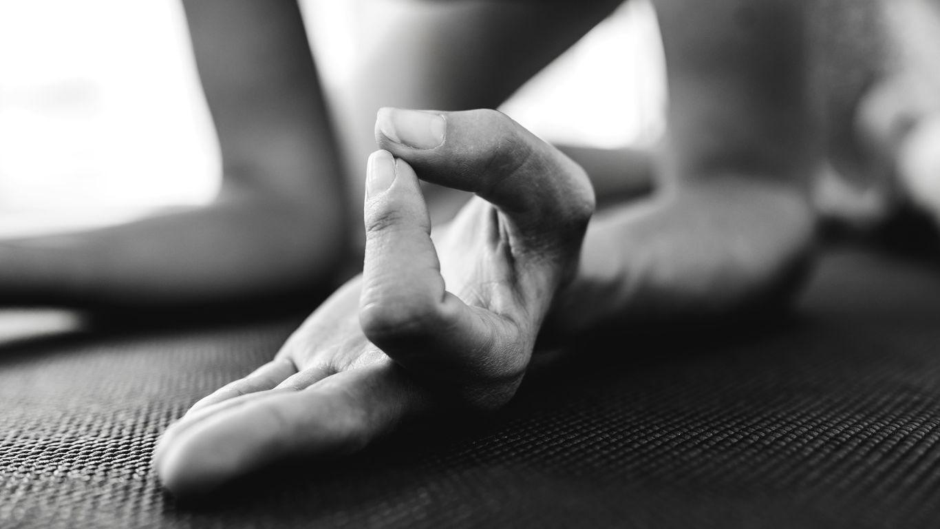 Hands adjusting a yoga strap safely