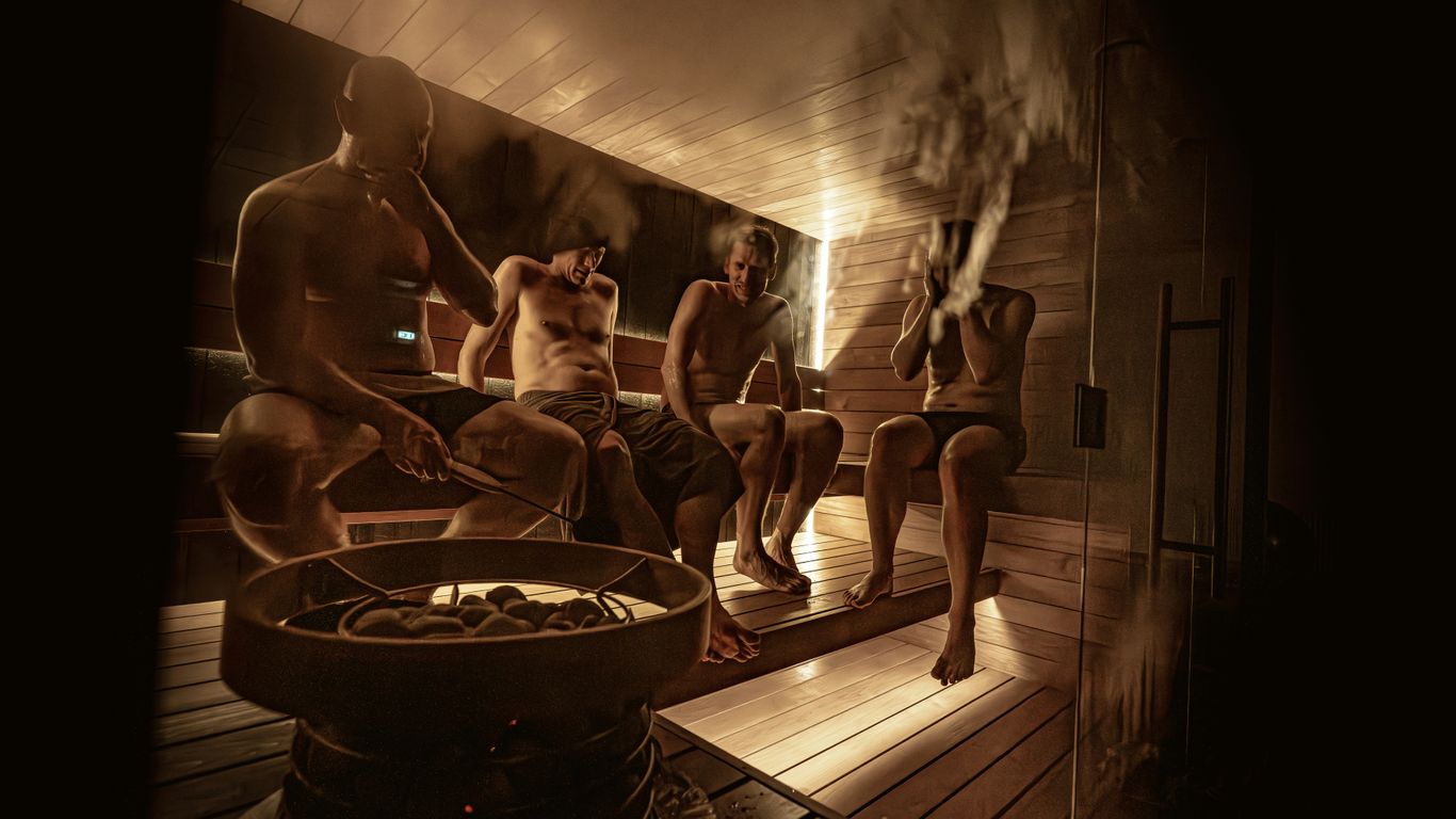 People relaxing in a steamy wooden sauna