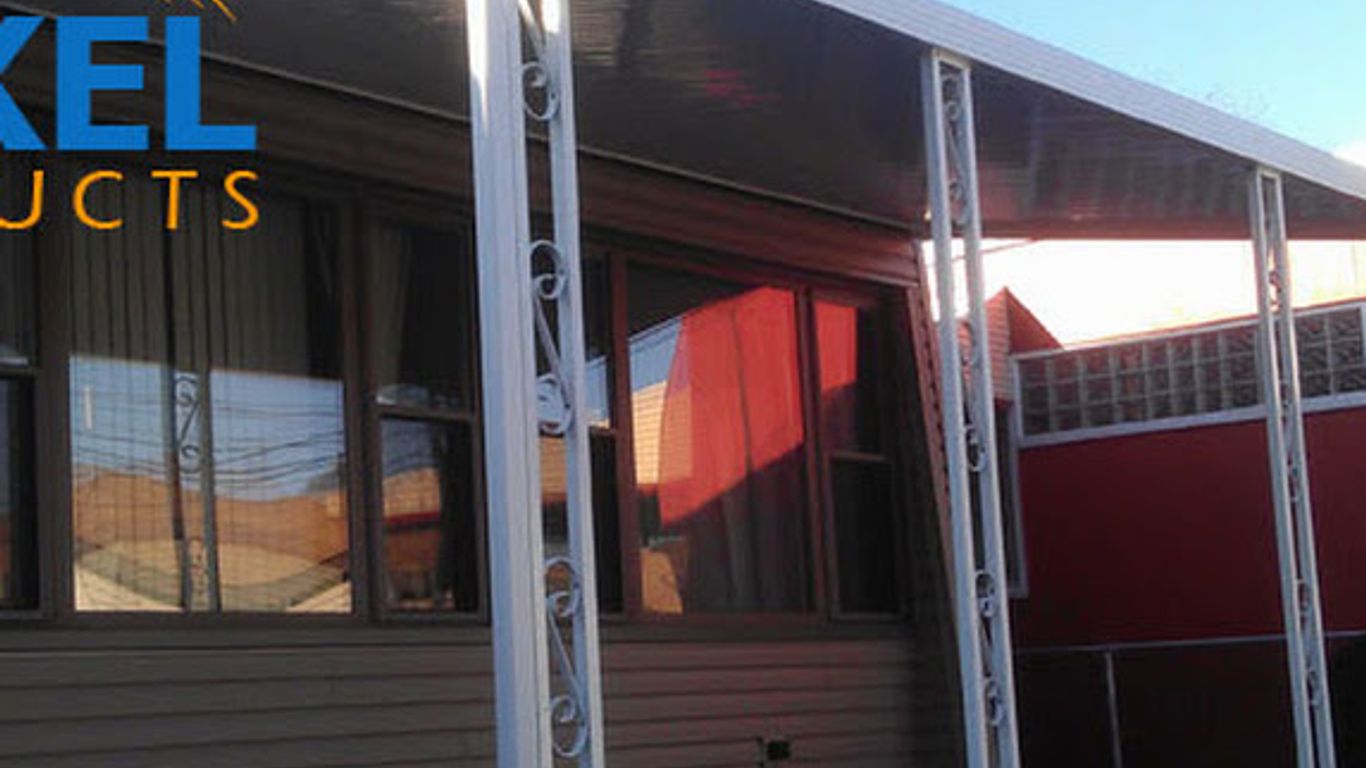 A white awning extends over a patio with decorative white posts.