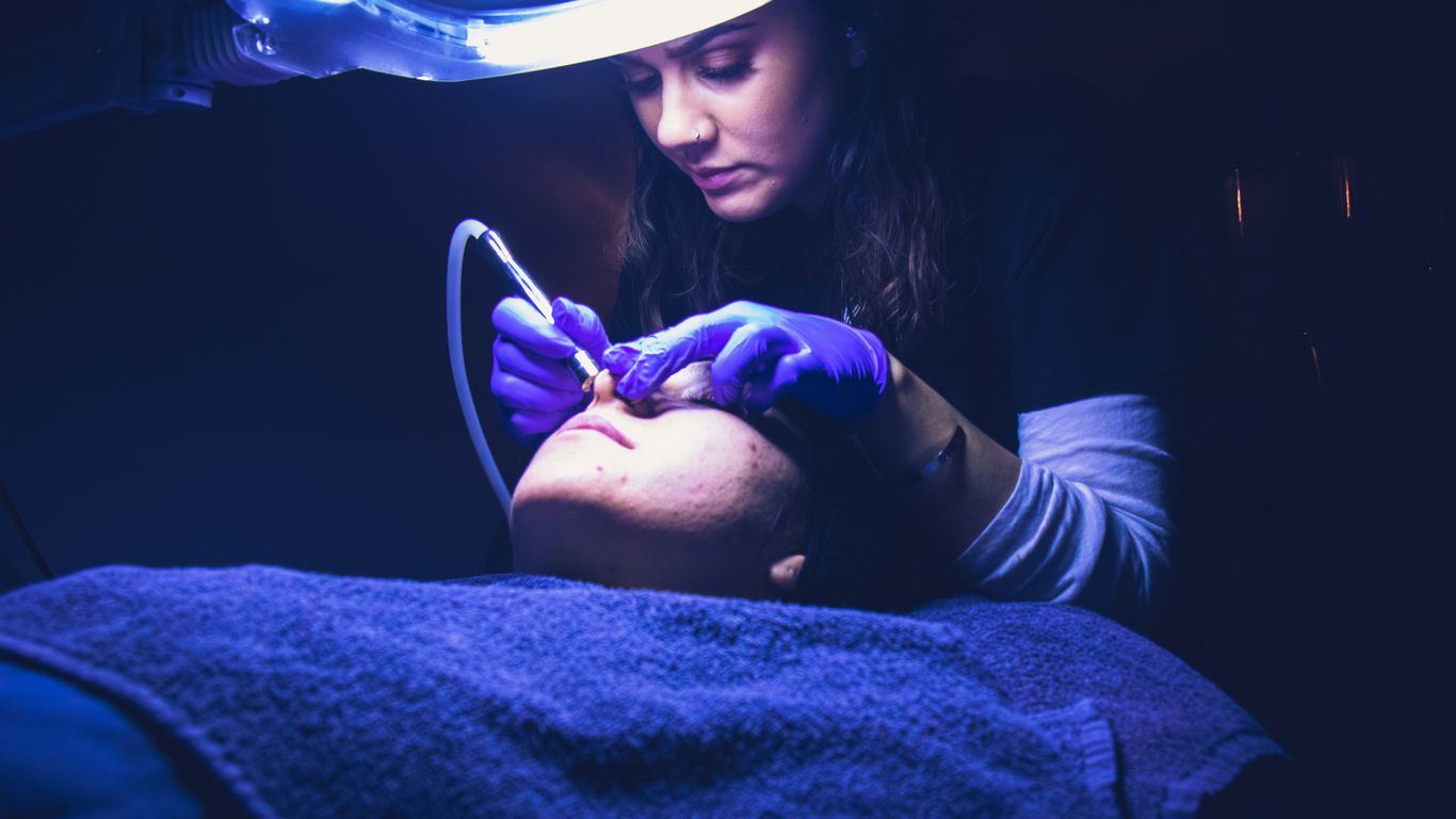 woman fixing another person's face