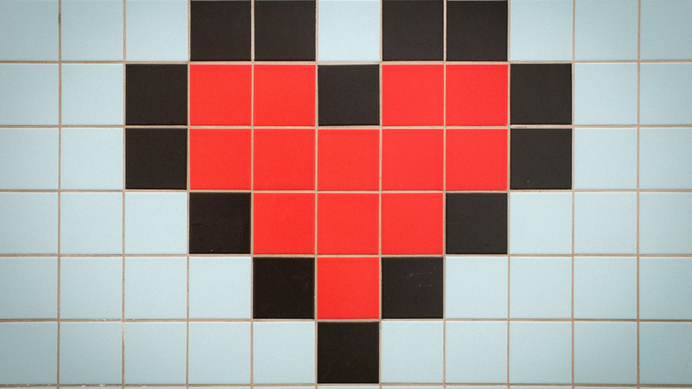Pixelated red heart on a light blue tiled background