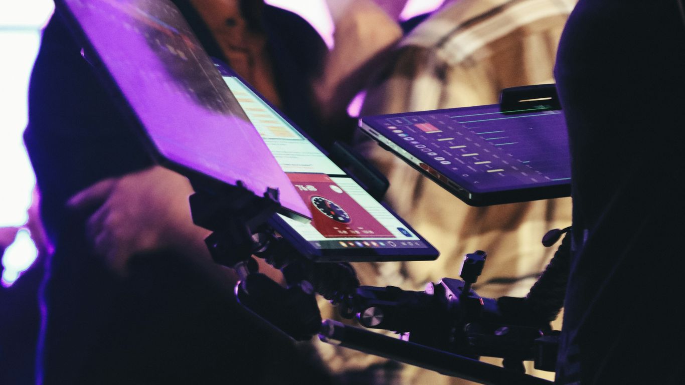 Person holding a tablet with a red card displayed