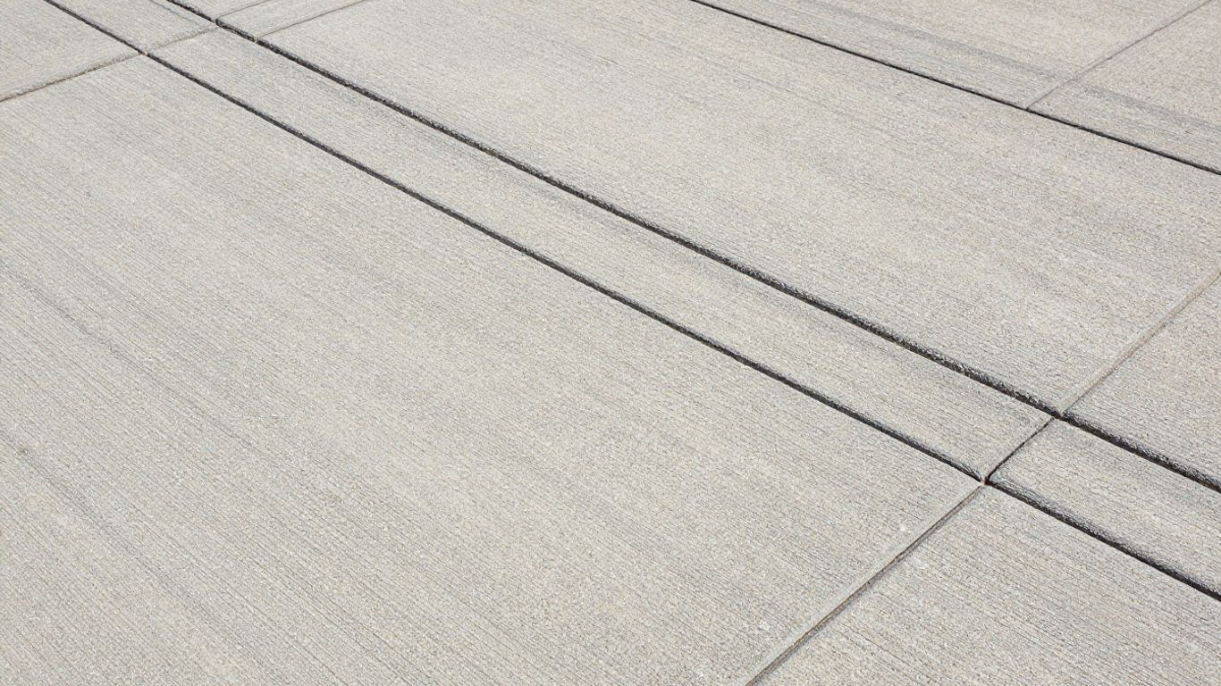 Stamped concrete walkway with stone pattern.