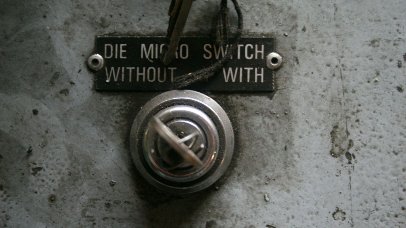 Close-up of a vintage electrical switch with label.
