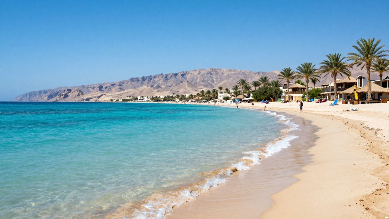 Sharm El Sheikh beach with turquoise water and mountains.