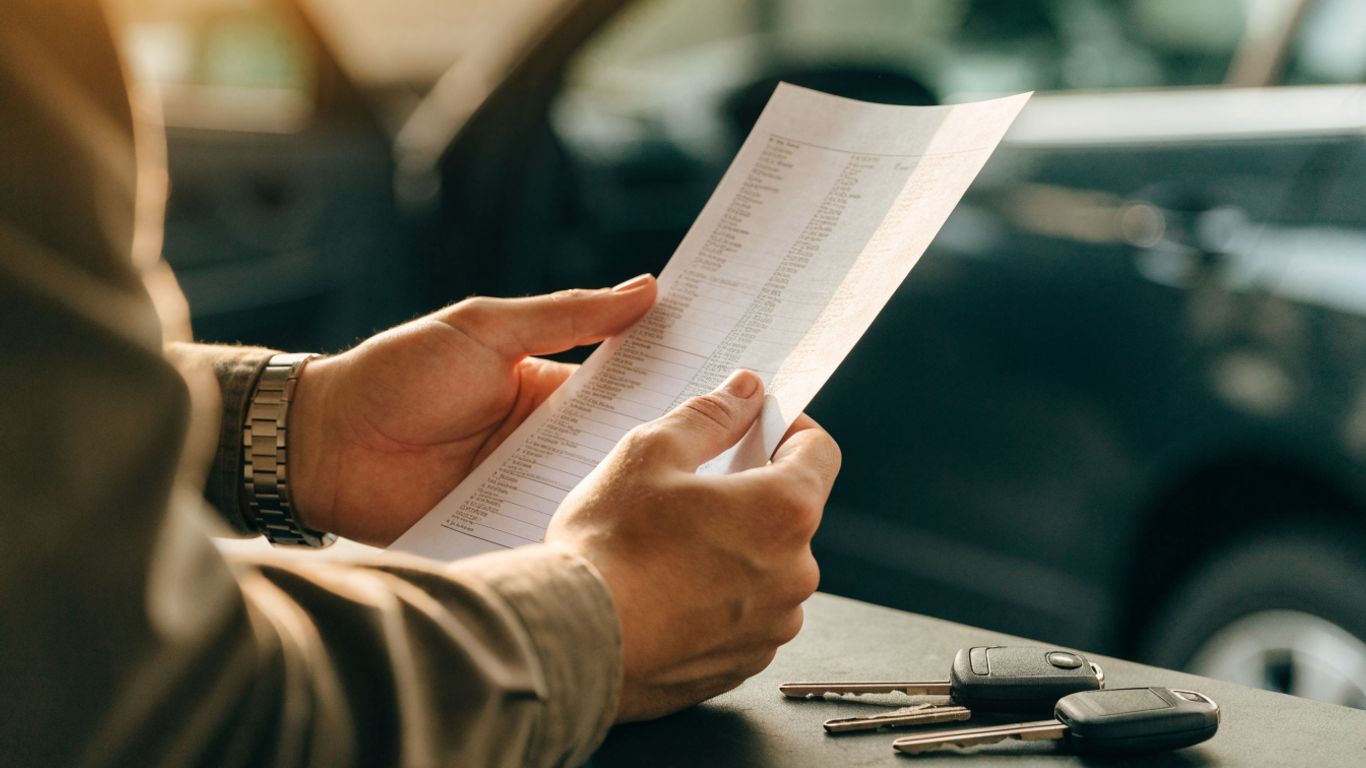 Written repair estimate beside vehicle keys