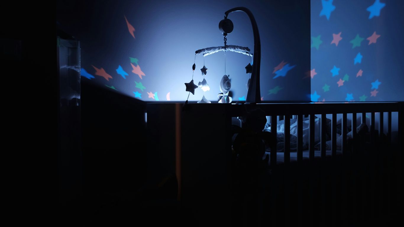baby's black wooden crib with LED crib mobile