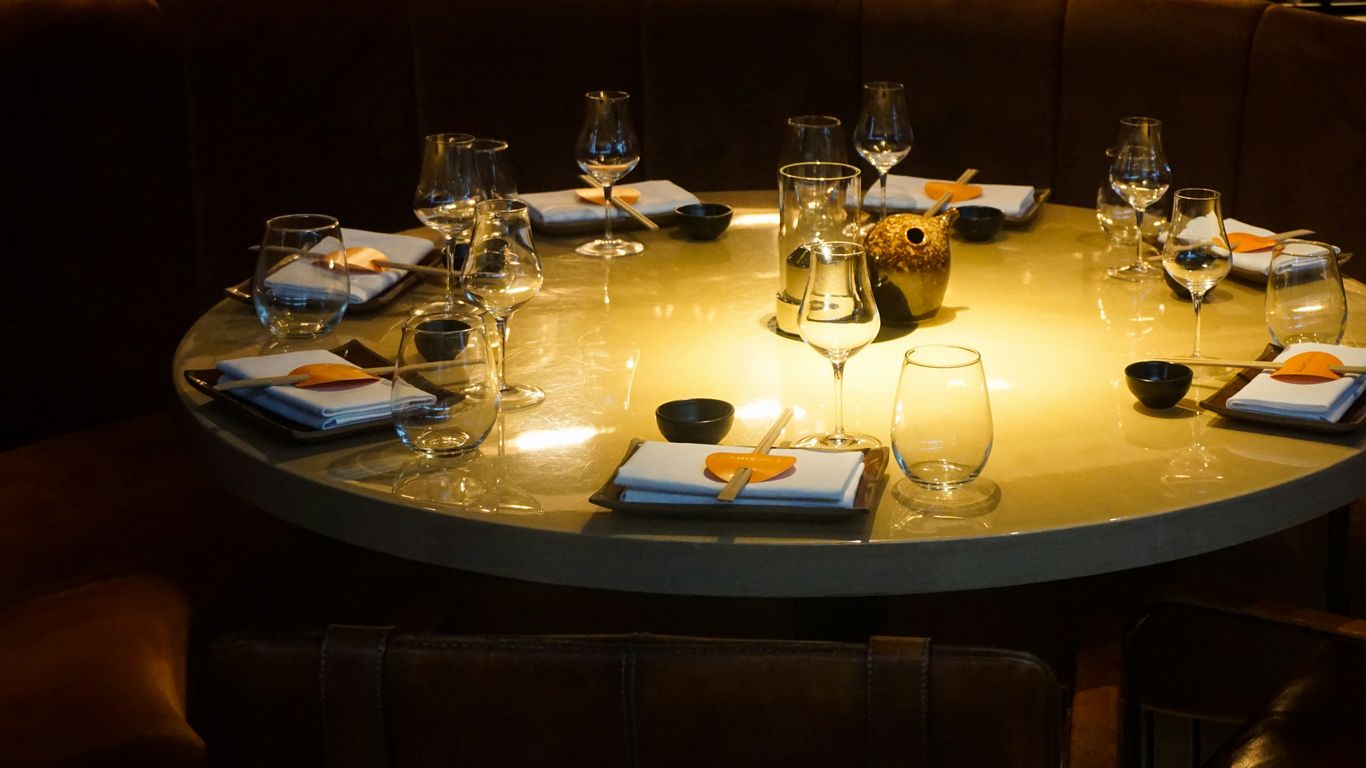 drinking glass and wine glasses on top of brown table