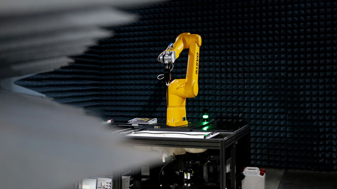 a yellow robot sitting on top of a table