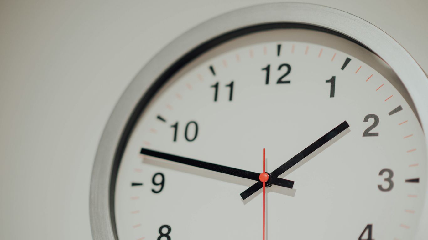 round silver analog wall clock displaying 1:48 time