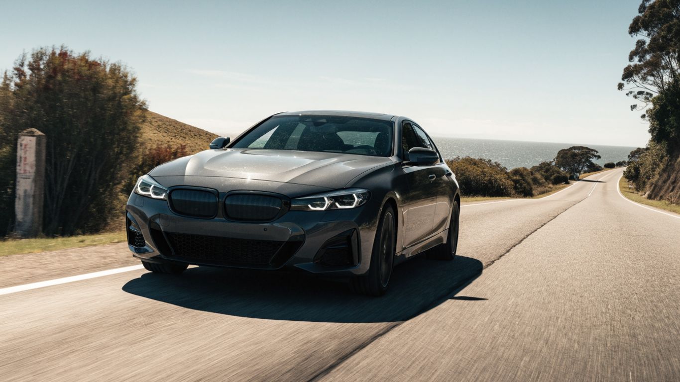 BMW driving over a coastal road bump