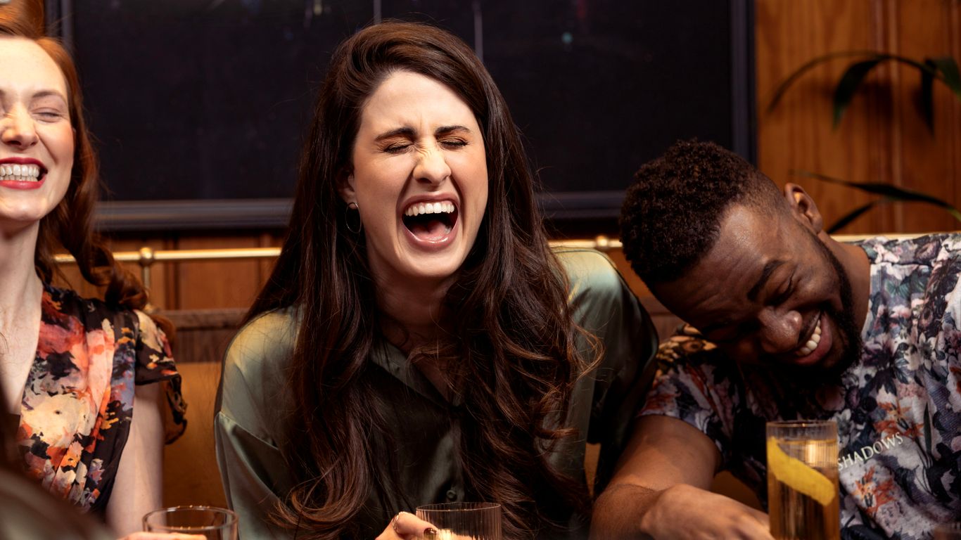 a group of people sitting around a table with drinks
