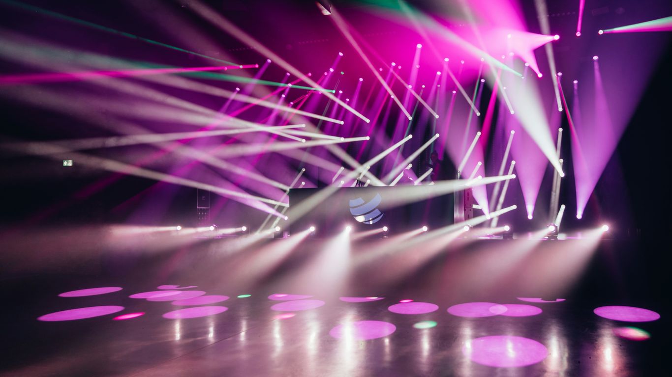 A vibrant event stage with lighting and modern seating