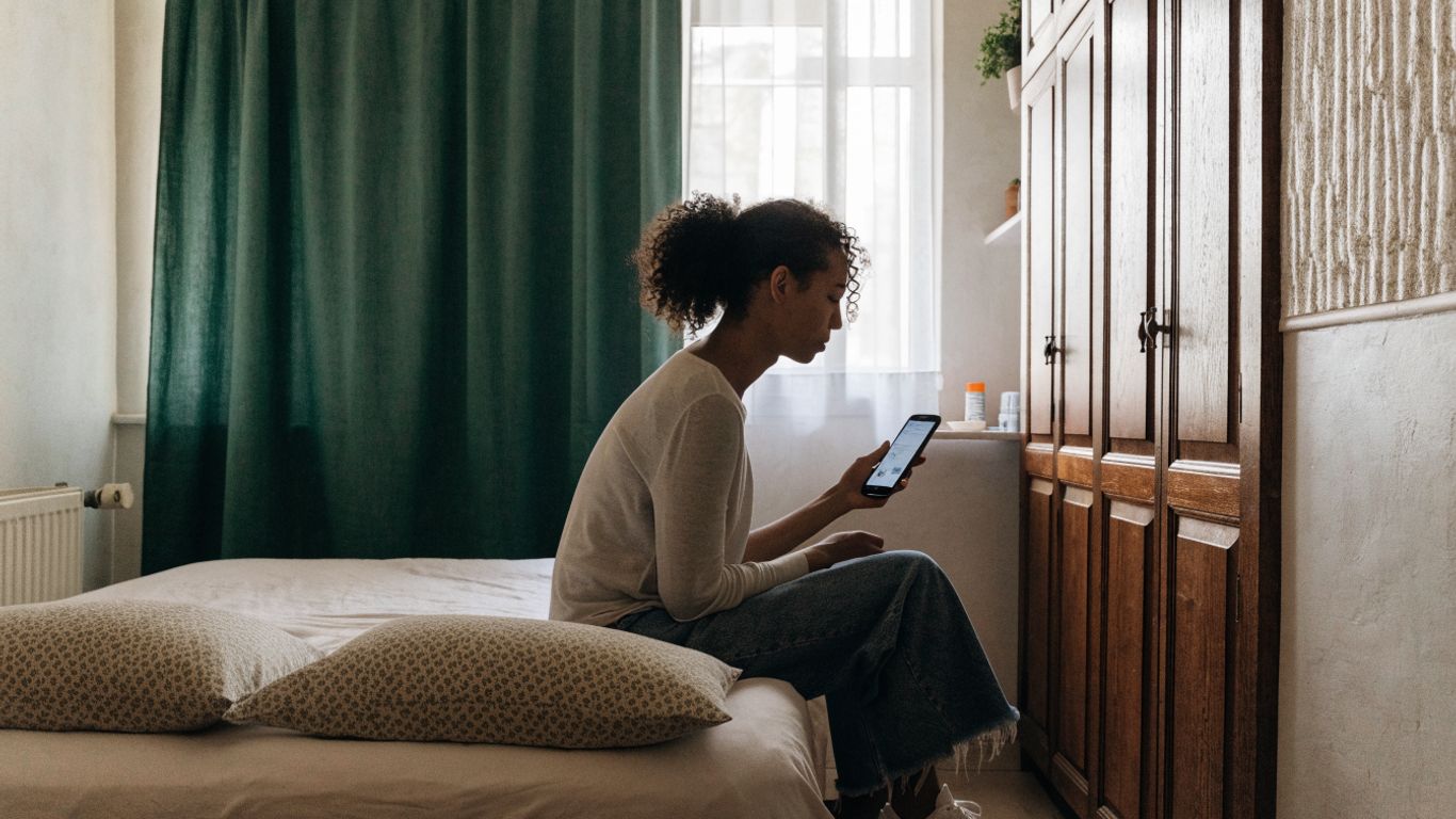 A traveller checking a Lisbon room booking on a phone