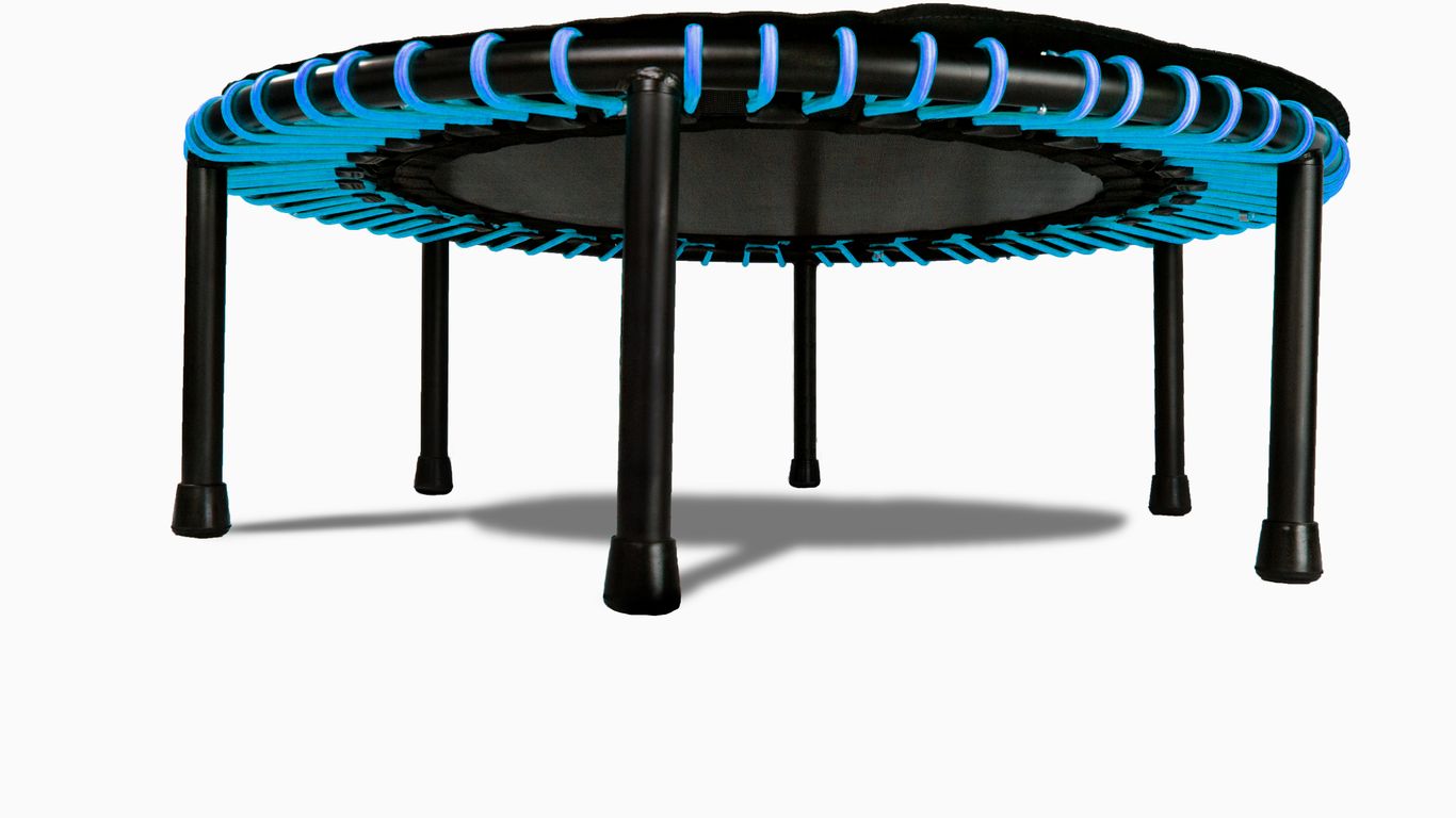 Small round trampoline with blue accents and black legs, isolated.