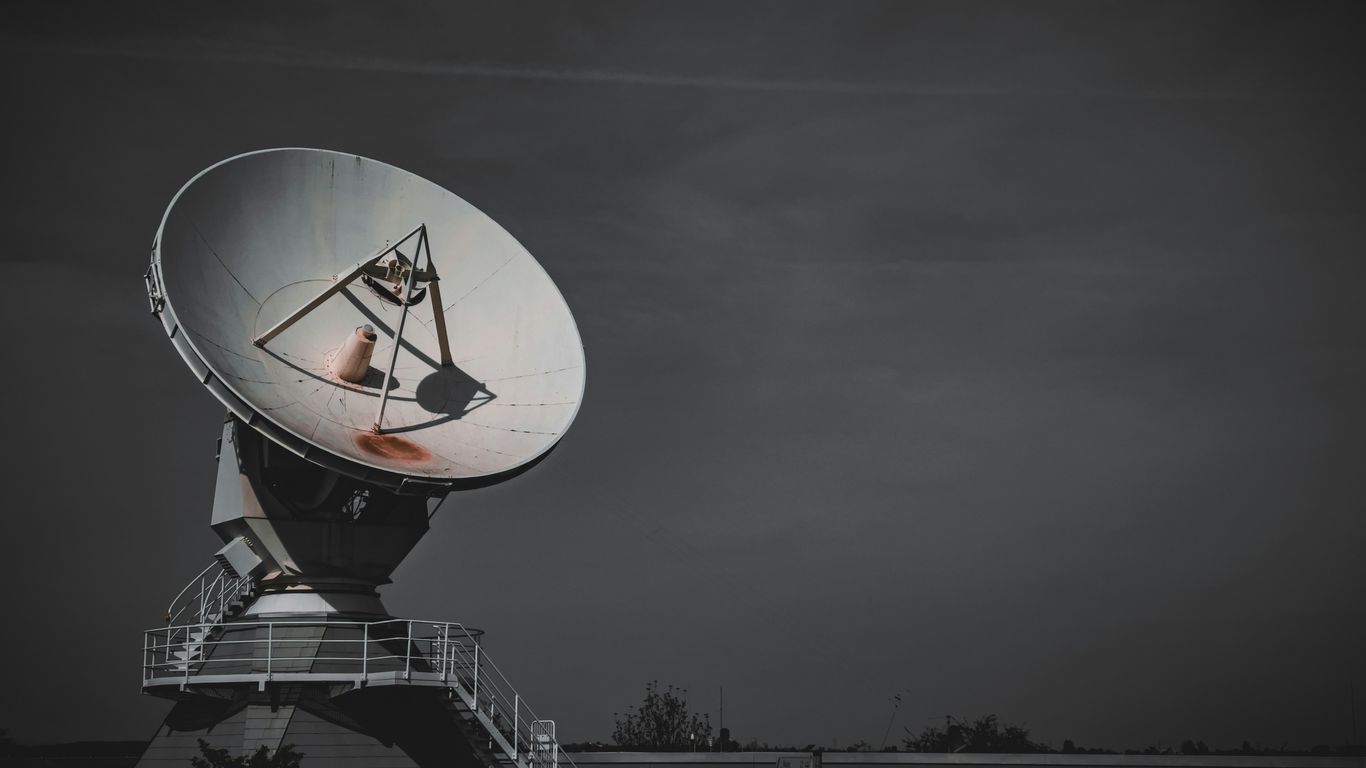 a large satellite dish sitting on top of a metal platform