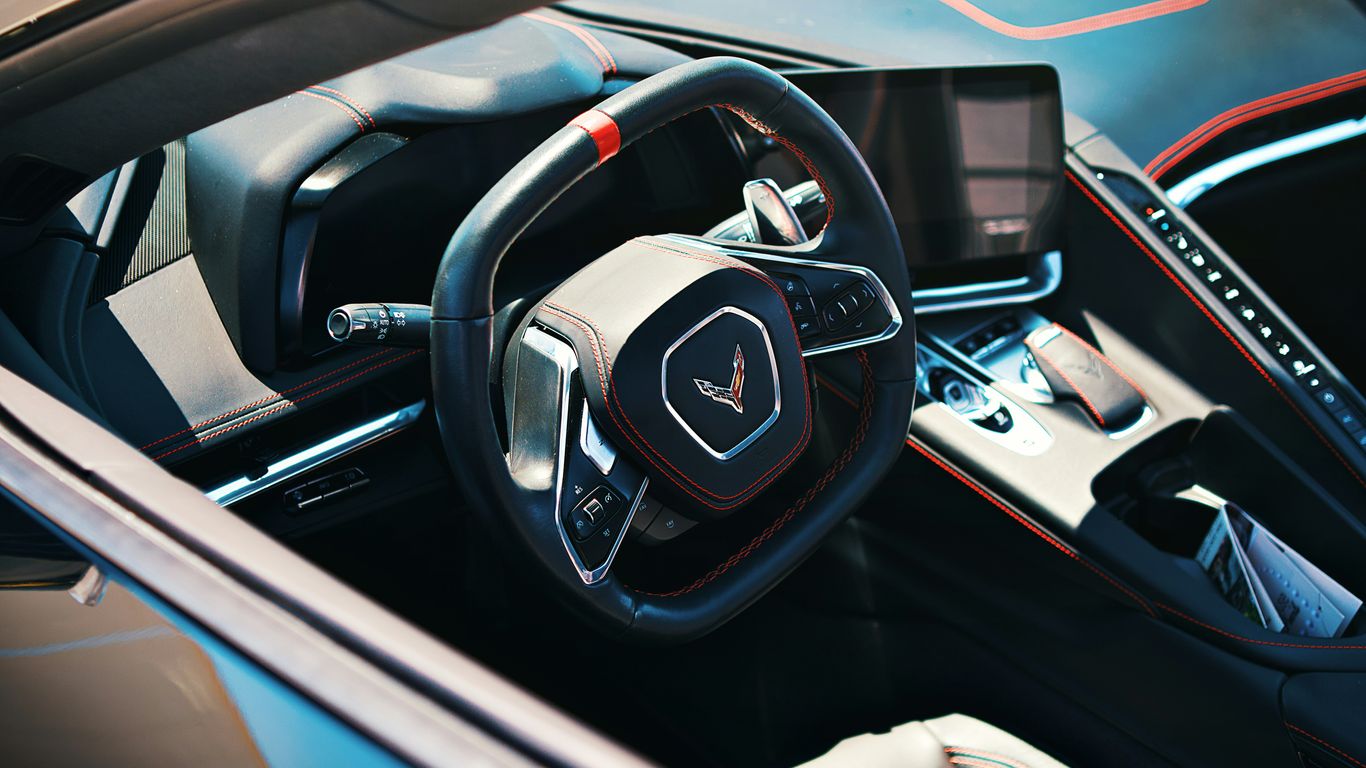 A modern car interior showcasing the steering wheel.