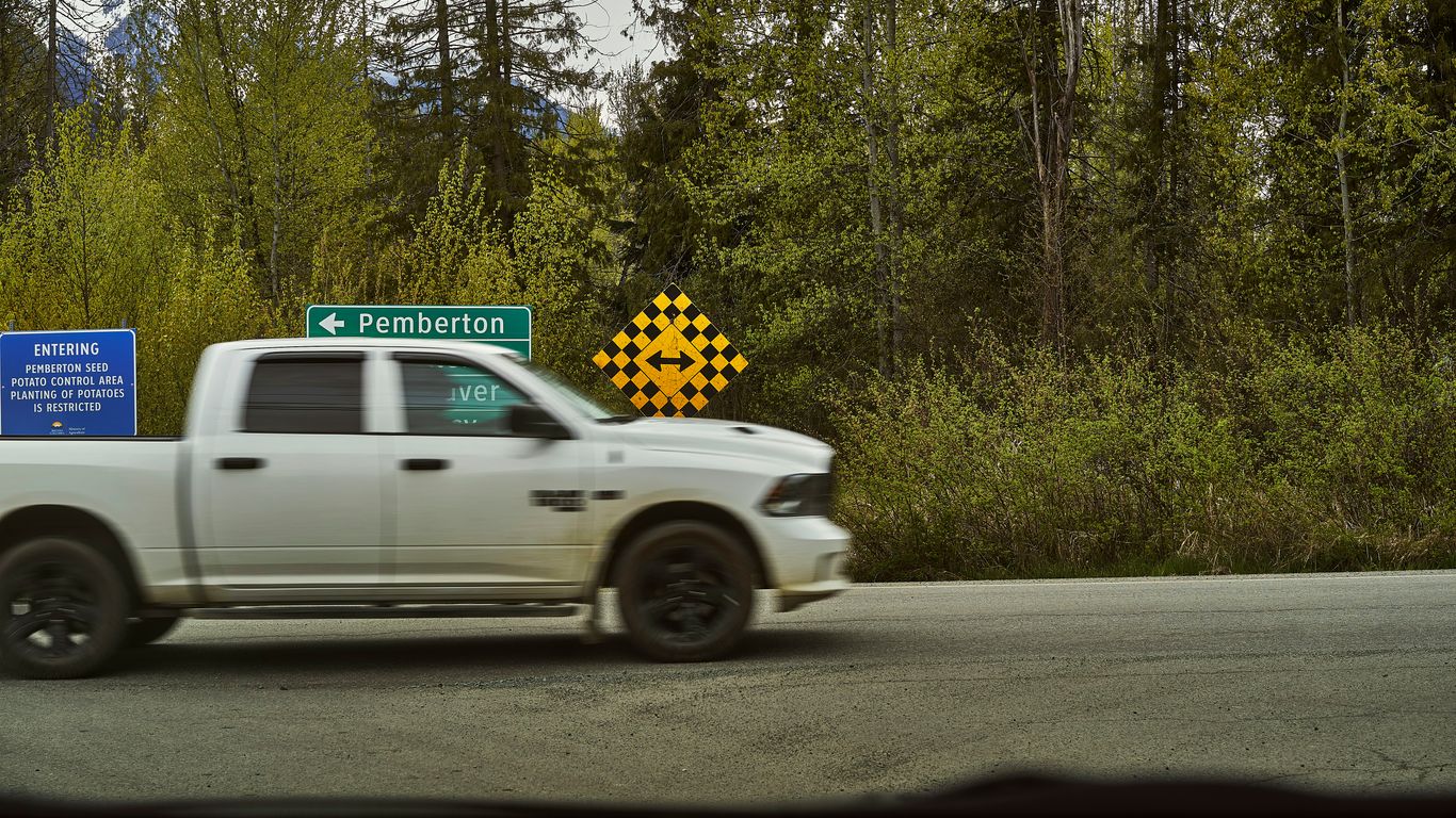 a white truck with a yellow sign on the back