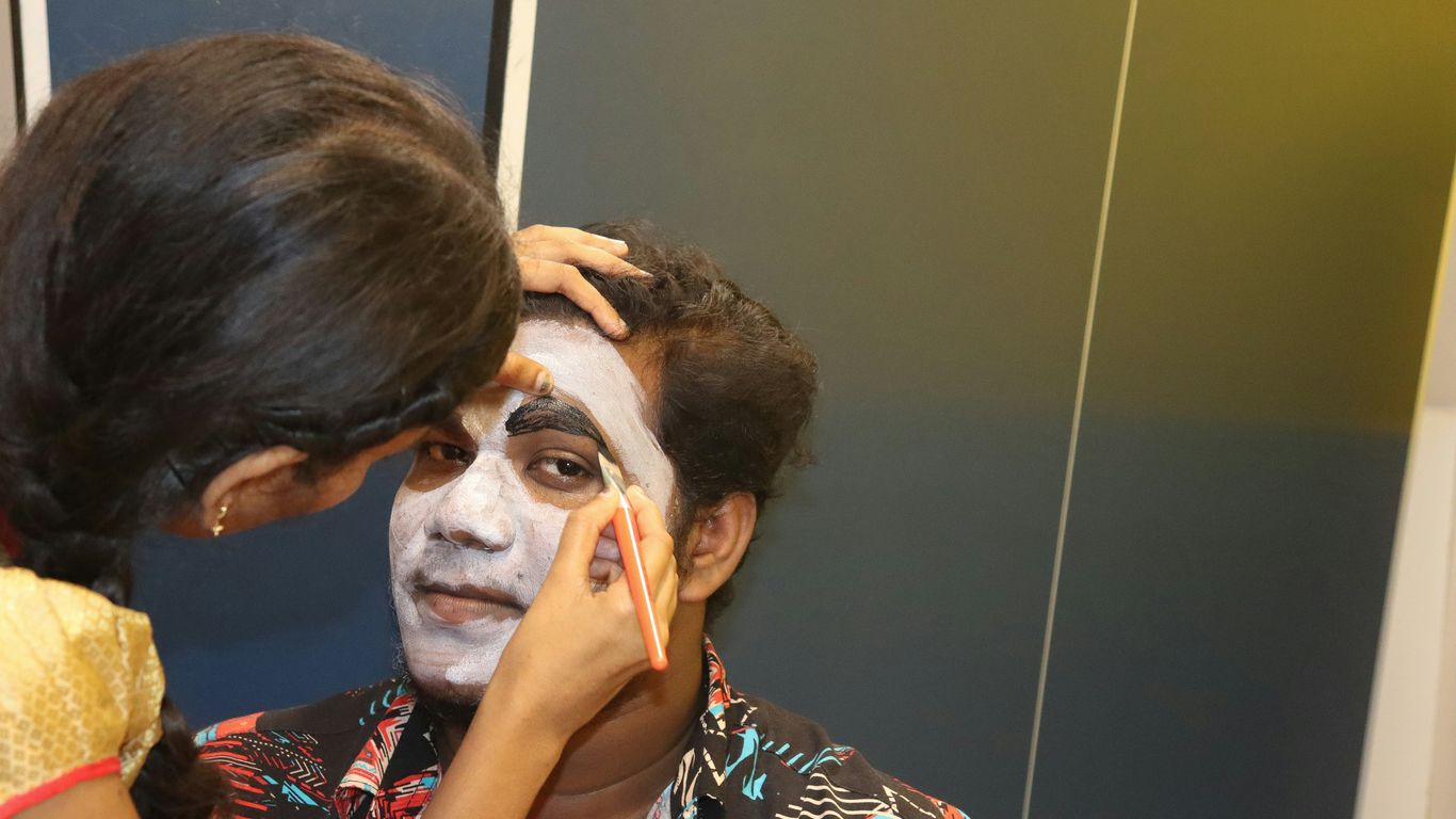 a woman is getting her face painted