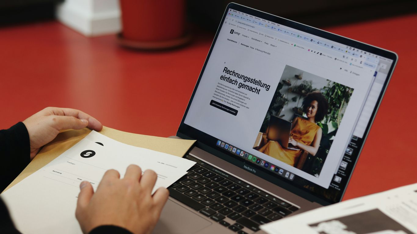 A person sitting at a table with a laptop