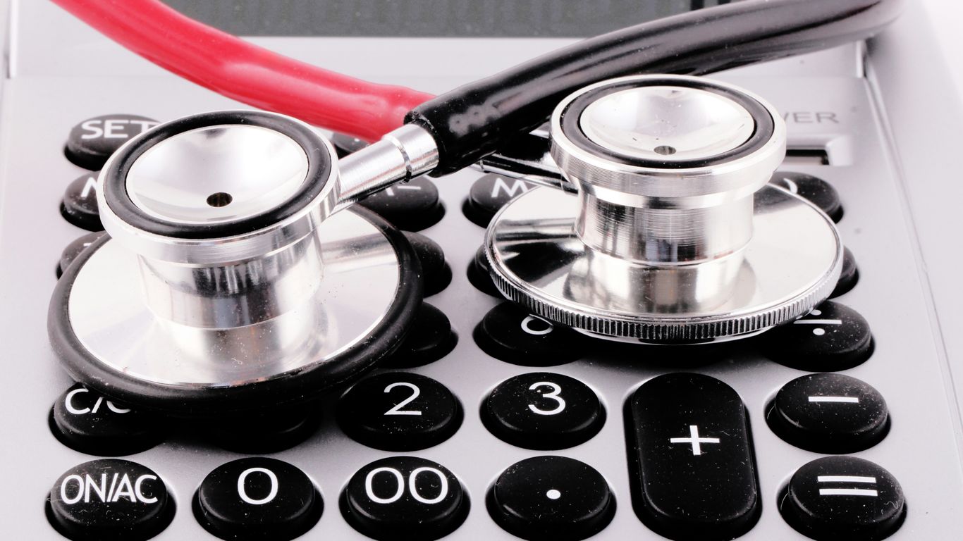 a stethoscope sitting on top of a calculator