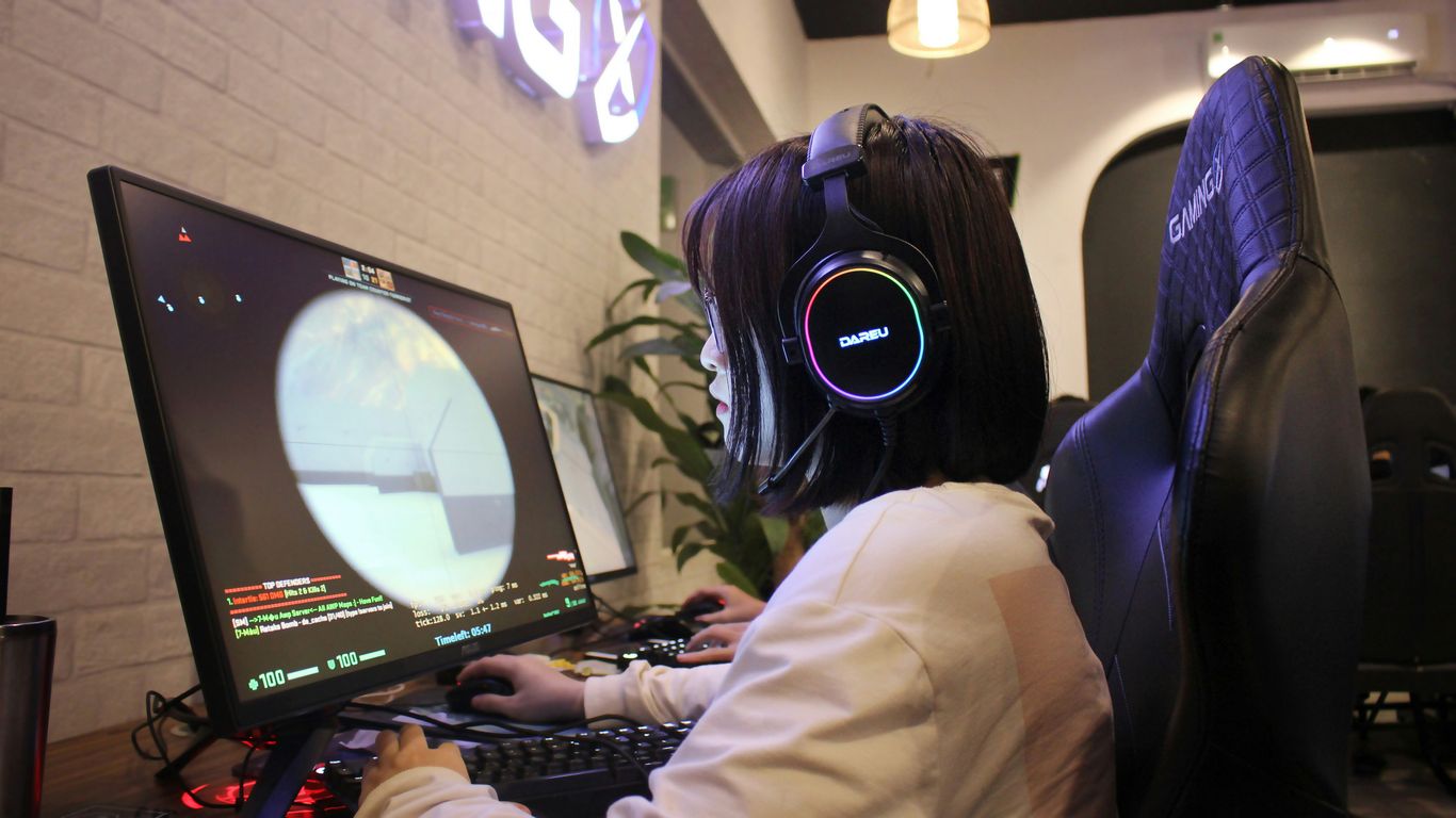 a person wearing headphones sitting in front of a computer