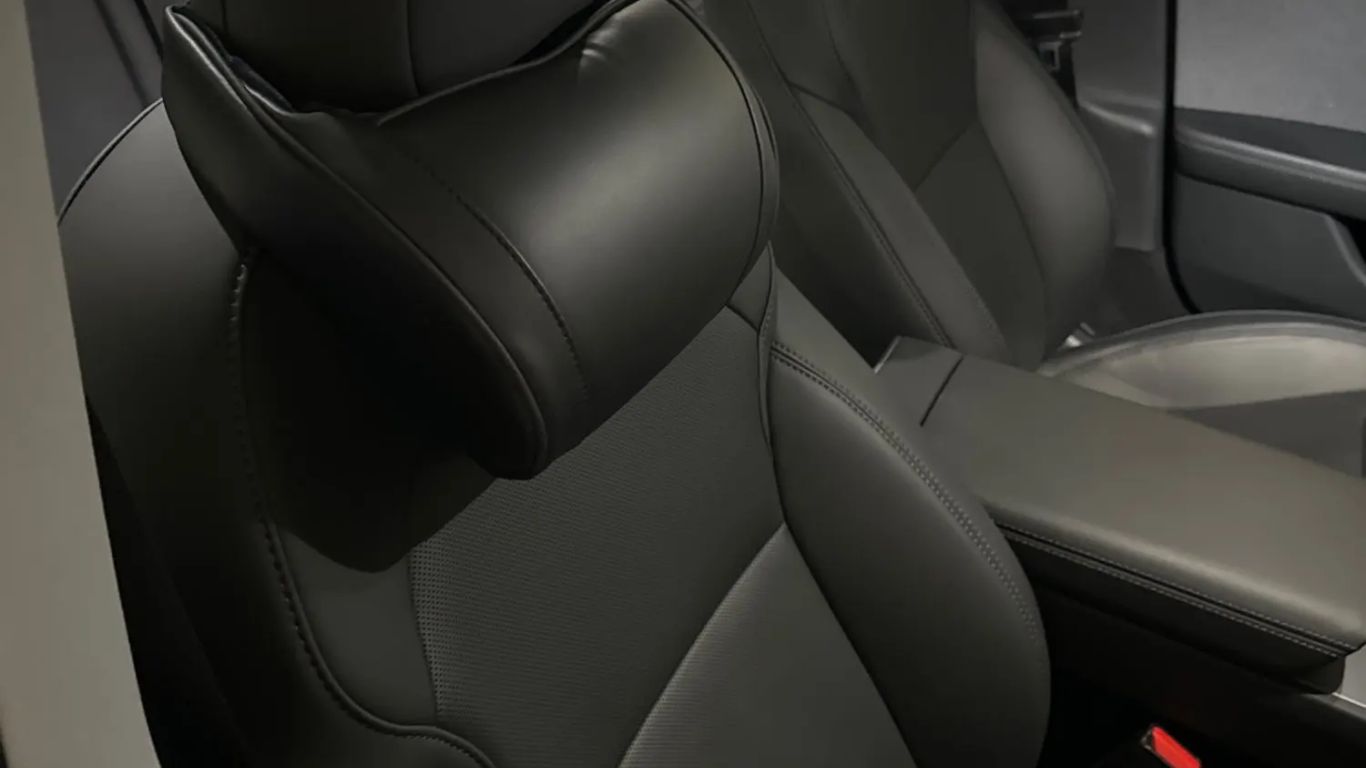The image shows modern car seats in a sleek interior.