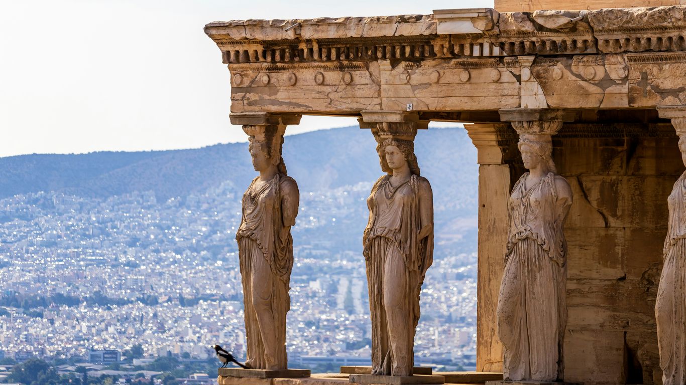 A group of statues on the side of a building