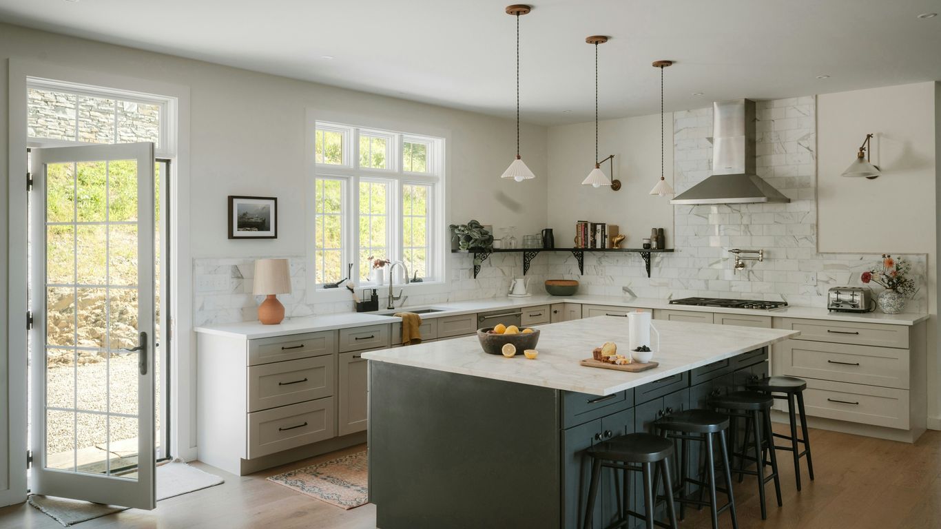 Modern kitchen with island and stainless steel appliances.