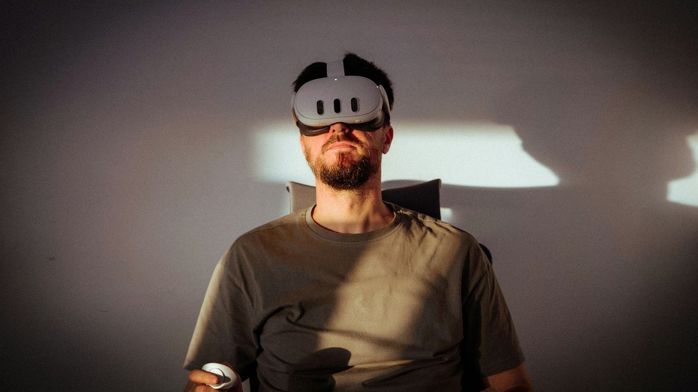 a man wearing a mask and holding a remote