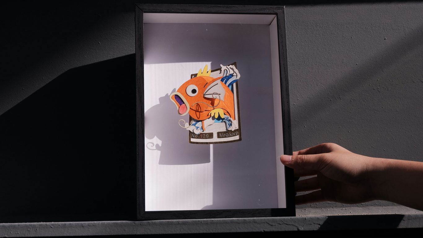 a picture of a hand holding a picture of a fish