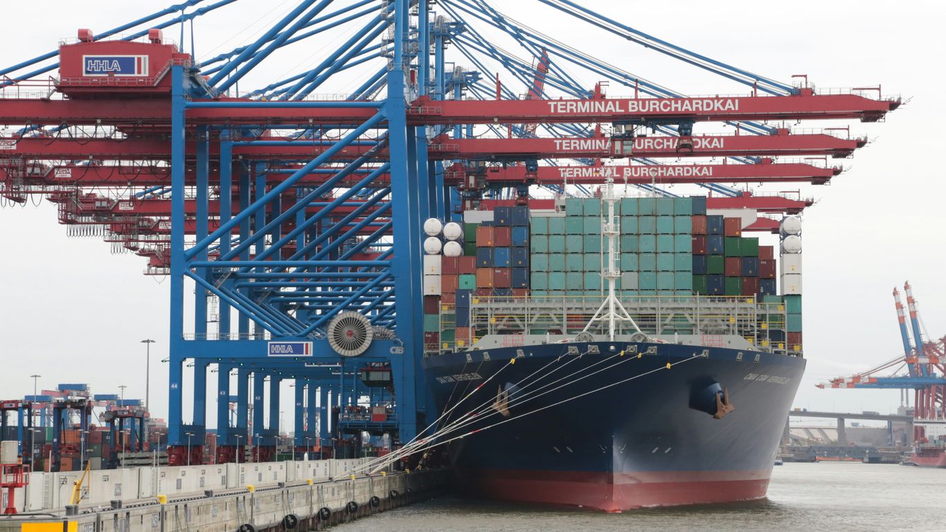 blue and red cargo ship on sea during daytime