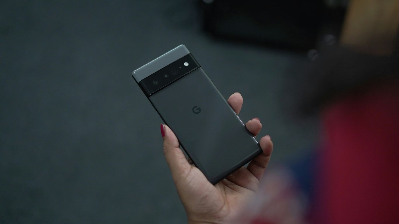 a hand holding a black phone