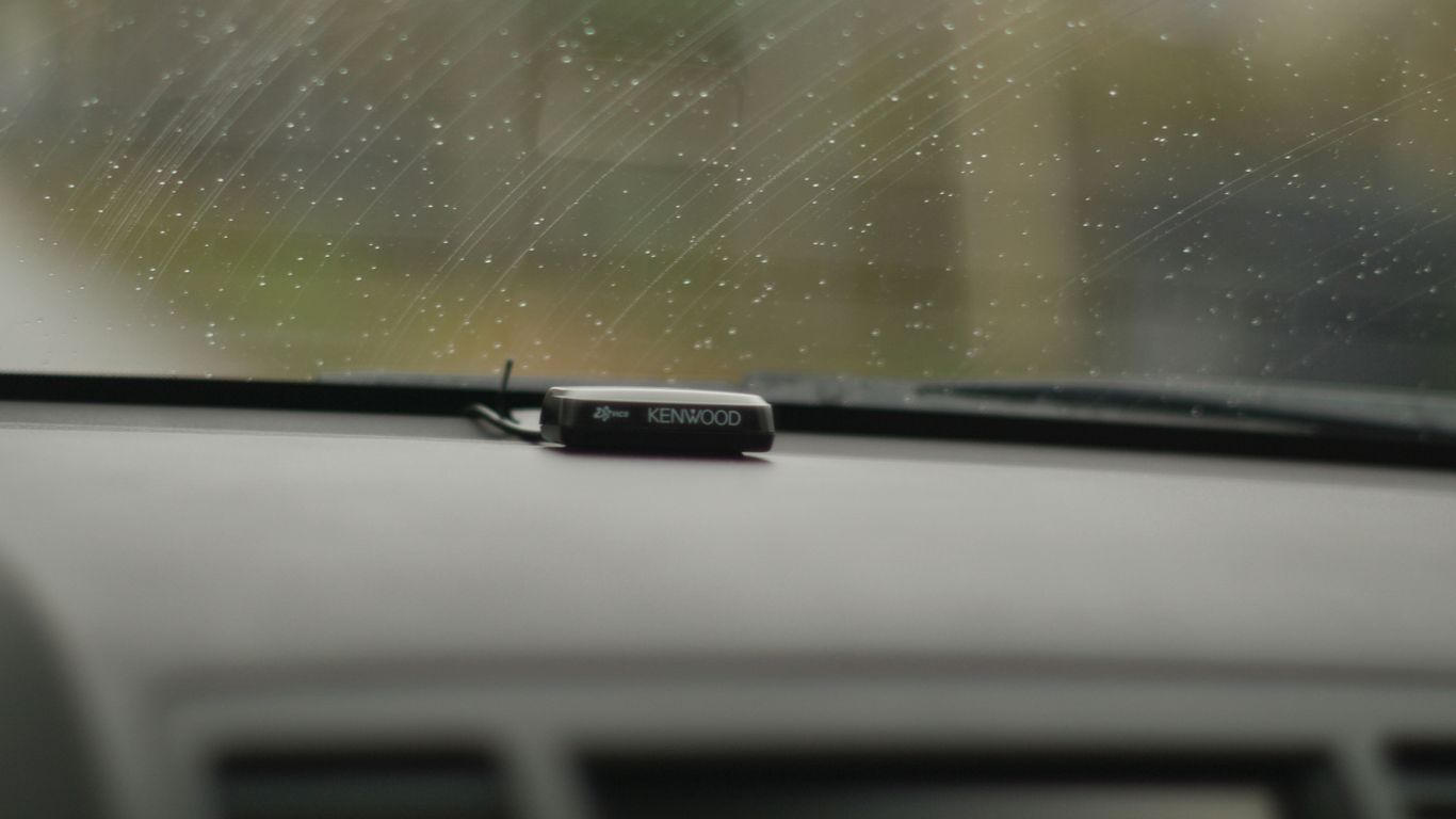 a close up of a car dashboard with rain coming down