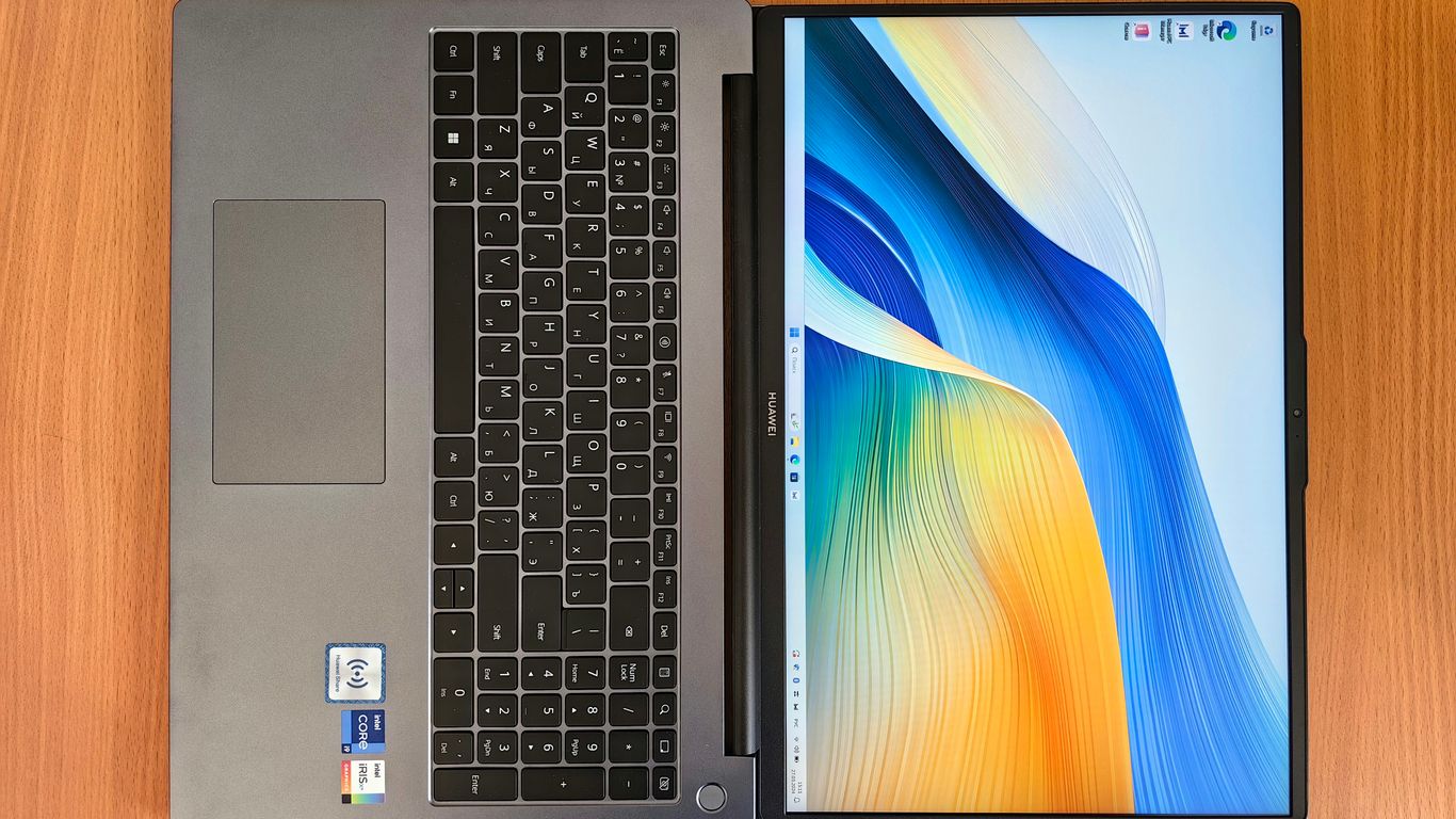 a laptop computer sitting on top of a wooden table