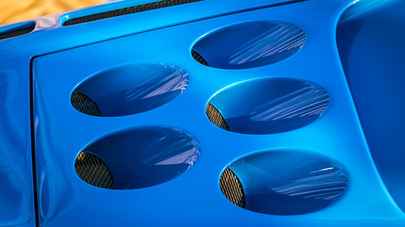 A close up of a blue car with holes in it