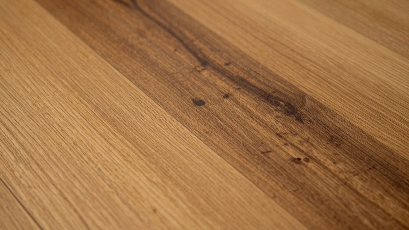 Oak floorboards showing dark tannin pull stains.