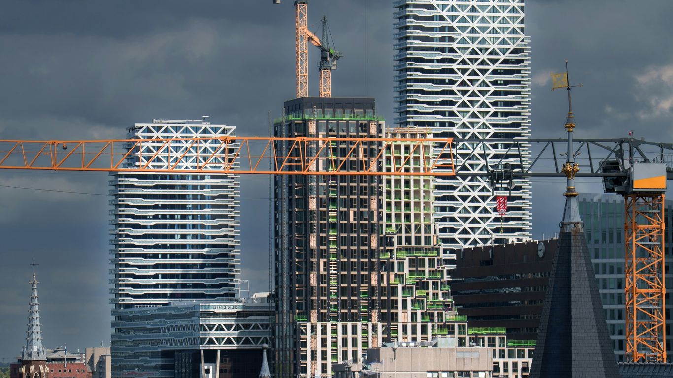 Modern buildings under construction with cranes