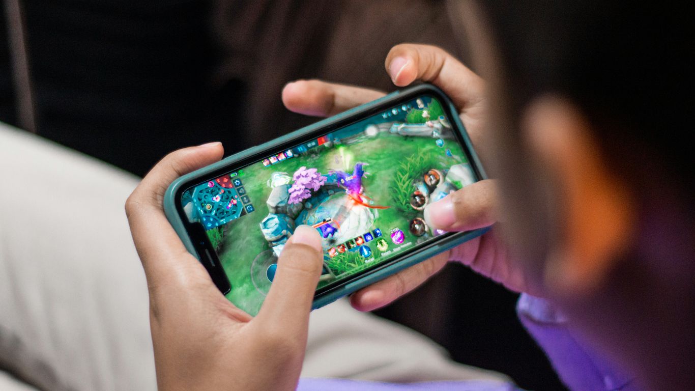 a person is playing a video game on their phone